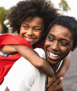 happy-african-family-having-fun-on-the-beach-during-summer-holidays-e1657706530227.jpg